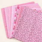 Pink cotton fabric bundle — seven 25 cm squares on cream