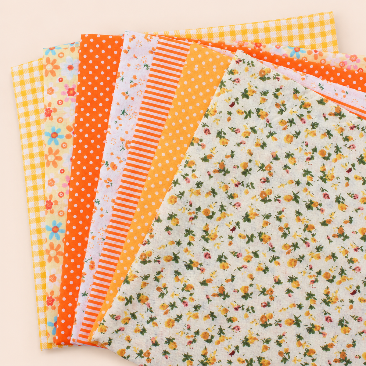Orange 2 cotton fabric bundle — seven 25 cm squares on cream