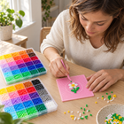 Illustrative scene: an adult making a small pixel flower at a craft table