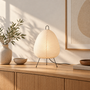 White paper lamp on a timber sideboard in afternoon light